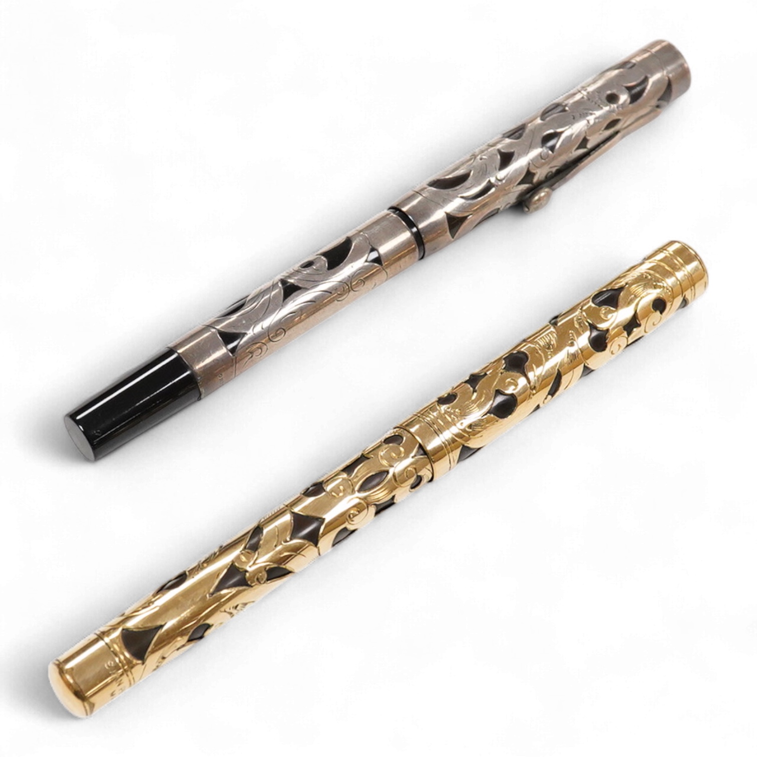 A Swan MT & Co. sterling silver filigree eyedropper along with similar gold filled example